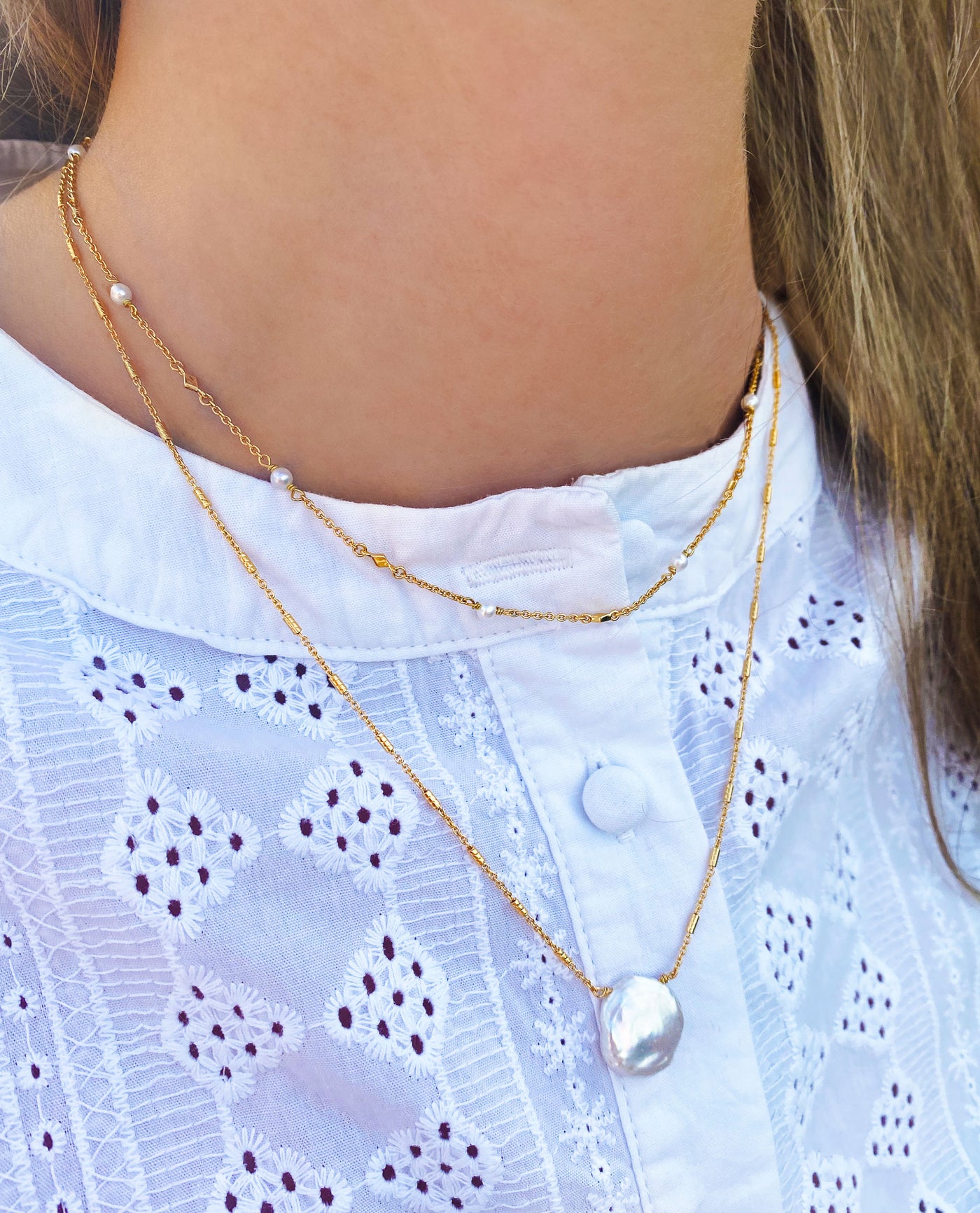 Model wearing gold plated sterling silver freshwater pearl necklace with dainty pearl choker