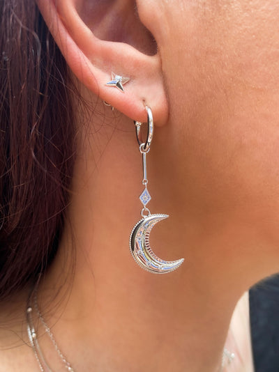 Model wearing statement sterling silver bar moon drop hoop earrings with CZ crystals and dainty star stud