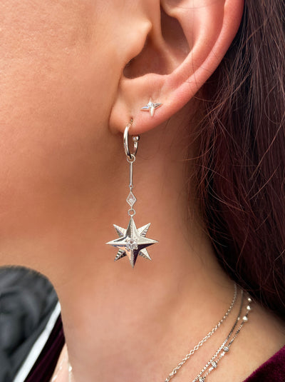 Model wearing statement sterling silver bar star drop hoop earrings with CZ crystals and dainty star stud