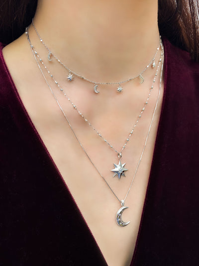 Model wearing sterling silver star necklace on bobble chain with dainty star and moon choker and moon pendant