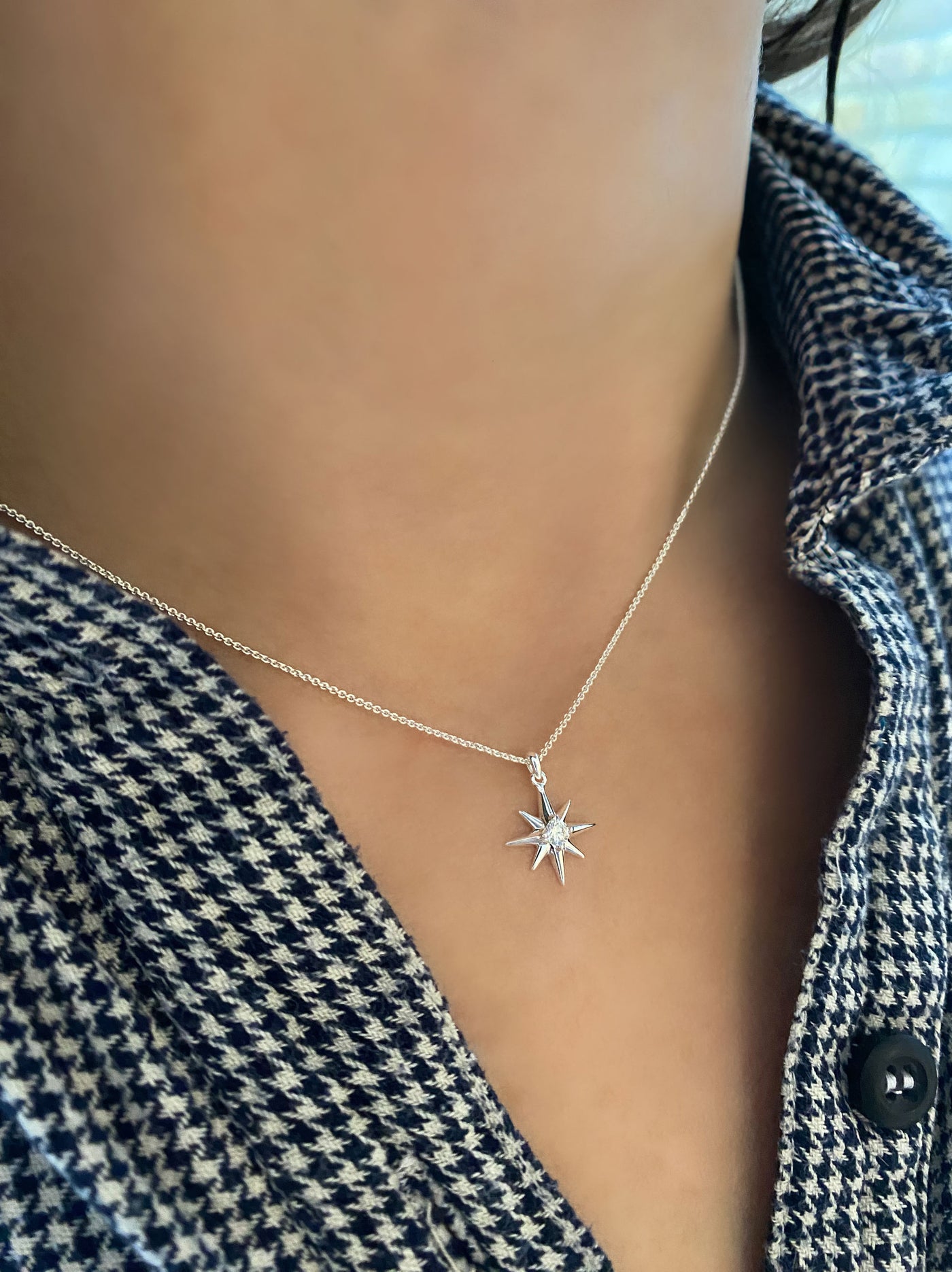 Model wearing dainty silver star necklace with CZ crystal 