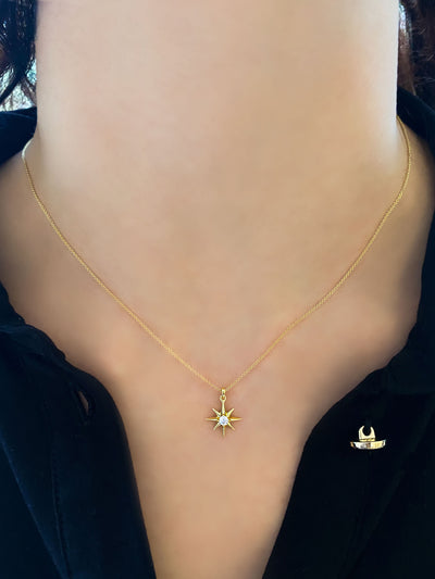 Model wearing gold dainty star necklace with CZ crystal 