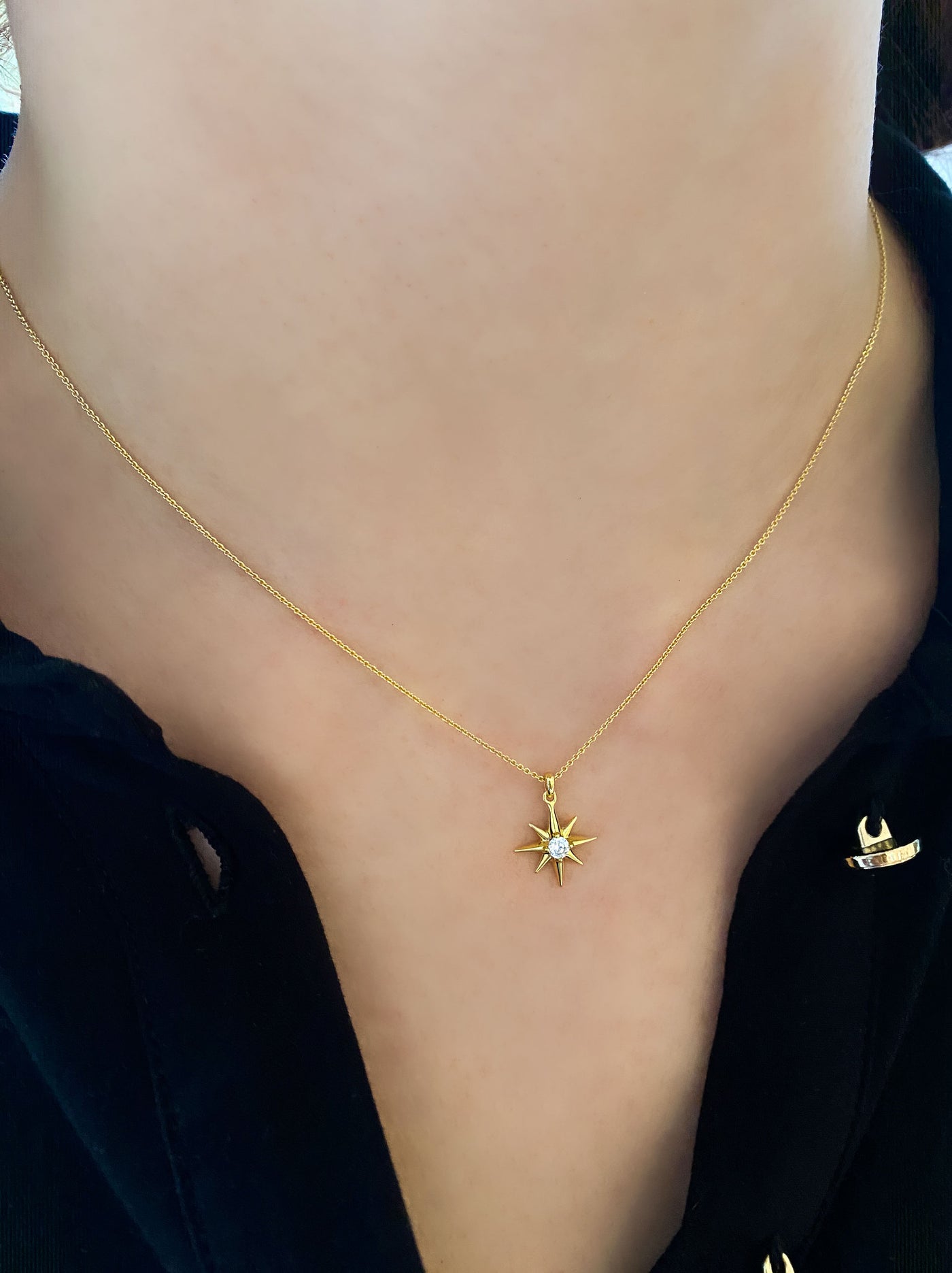 Model wearing gold dainty star necklace with CZ crystal 